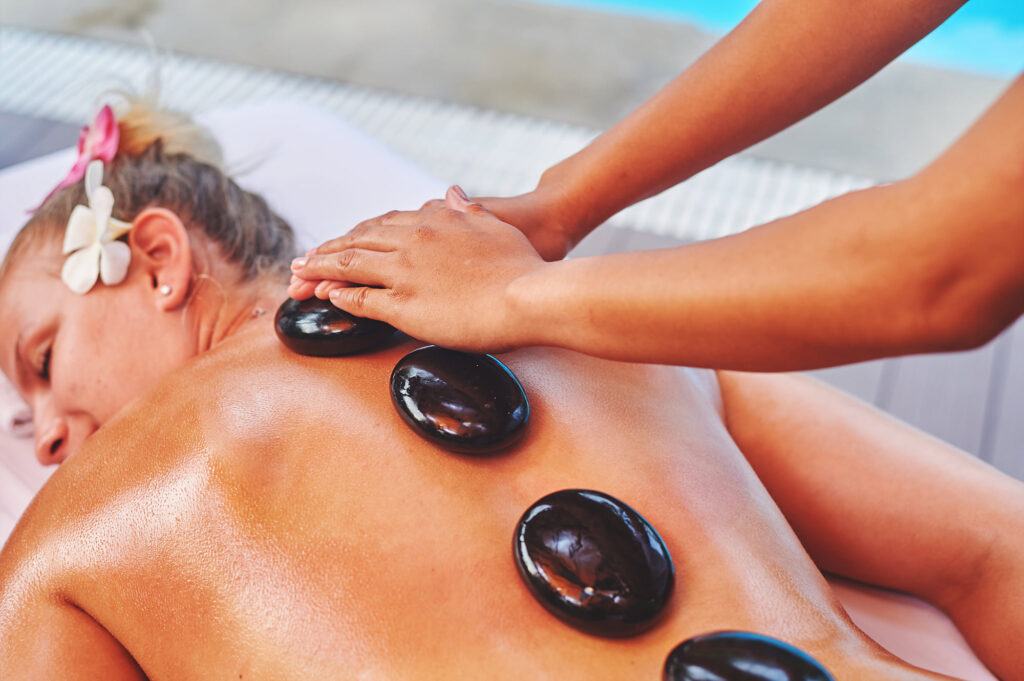 Guest embracing the warmth of lava stone massage